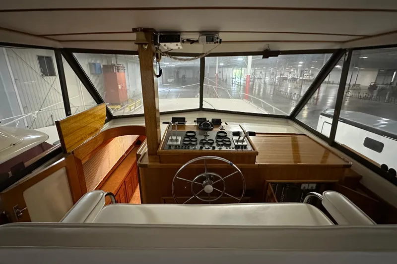 Slide: The Image of 1982 Egg Harbor 42 Flybridge Motoryacht helm with classic wooden dashboard and steering wheel. - 38