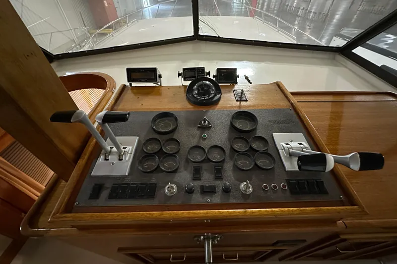 Slide: The Image of Control panel of 1982 Egg Harbor 42 Flybridge Motoryacht with gauges and levers. - 39