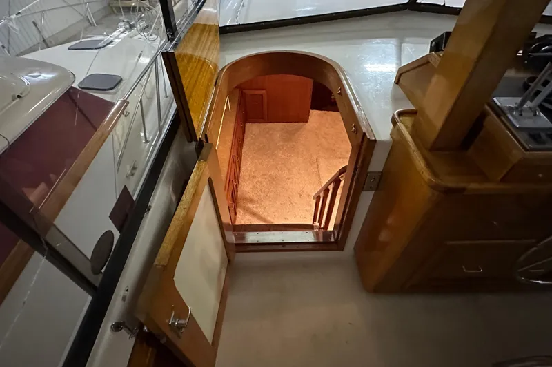 Slide: The Image of Interior view of 1982 Egg Harbor 42 Flybridge Motoryacht, showing stairs and wood paneling. - 46