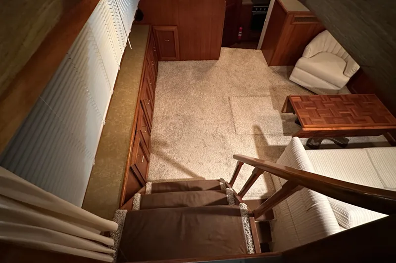 Slide: The Image of Interior of 1982 Egg Harbor 42 Flybridge Motoryacht with carpet, wood furniture, and staircase. - 48