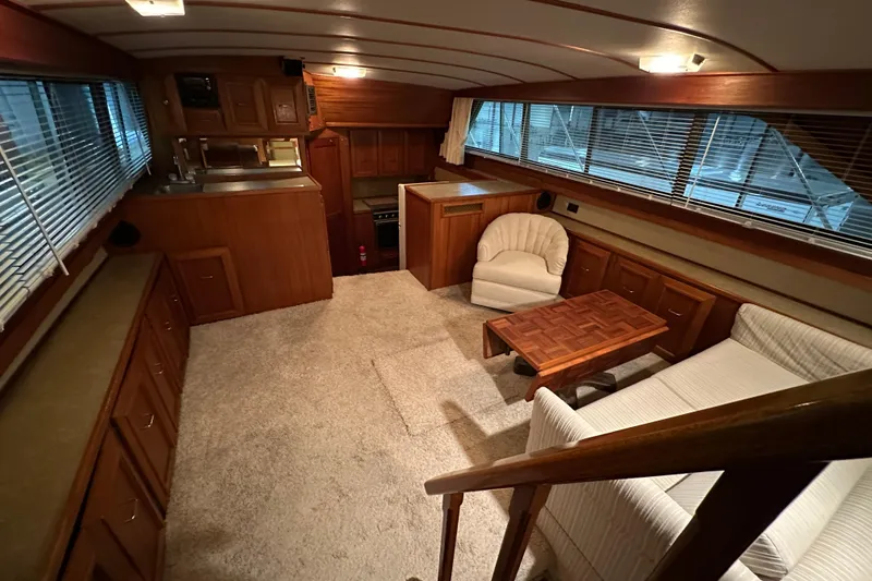 Slide: The Image of Interior of 1982 Egg Harbor 42 Flybridge Motoryacht with wood cabinetry and cozy seating area. - 49