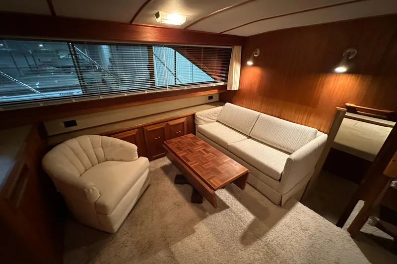 Slide: The Image of Interior of 1982 Egg Harbor 42 Flybridge Motoryacht with cozy seating and wooden accents. - 52