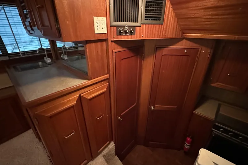 Slide: The Image of Interior of 1982 Egg Harbor 42 Flybridge Motoryacht with wooden cabinetry and kitchen area. - 59