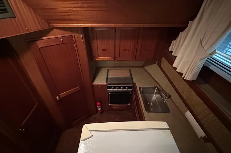 Slide: The Image of 1982 Egg Harbor 42 Flybridge Motoryacht kitchen with wood cabinetry and compact appliances. - 60