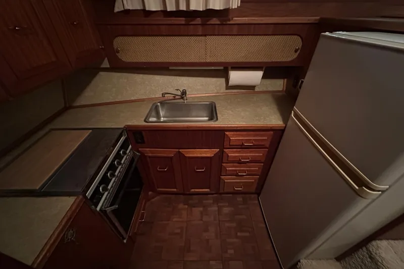 Slide: The Image of 1982 Egg Harbor 42 Flybridge Motoryacht kitchen with sink, stove, and refrigerator. - 62