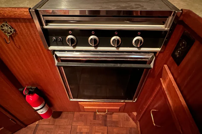 Slide: The Image of 1982 Egg Harbor 42 Flybridge Motoryacht kitchen with vintage oven and fire extinguisher. - 63