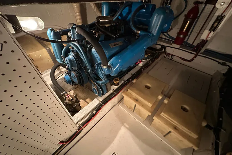 Slide: The Image of Engine room of 1982 Egg Harbor 42 Flybridge Motoryacht with blue engine components. - 70