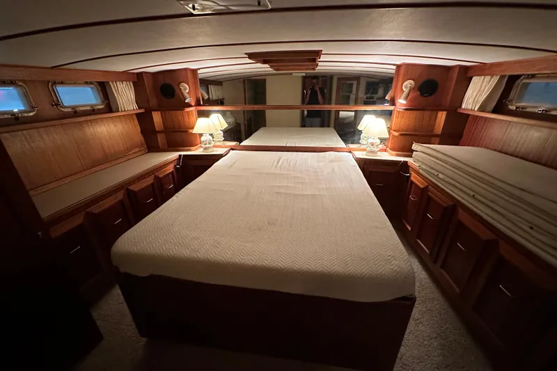 Slide: The Image of Luxurious 1982 Egg Harbor 42 Flybridge Motoryacht bedroom with elegant wood finish and cozy lighting. - 71