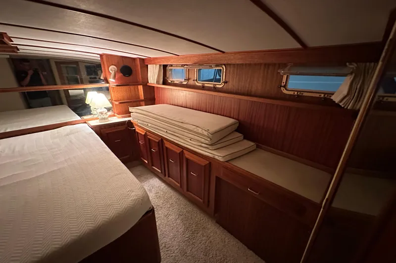 Slide: The Image of Cozy cabin interior of 1982 Egg Harbor 42 Flybridge Motoryacht with wood paneling and bedding. - 72