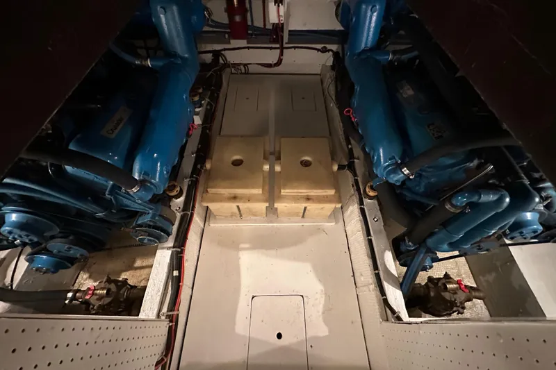 Slide: The Image of Engine room of 1982 Egg Harbor 42 Flybridge Motoryacht with dual blue engines. - 76