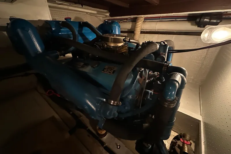 Slide: The Image of Engine room of 1982 Egg Harbor 42 Flybridge Motoryacht with blue engine components. - 78