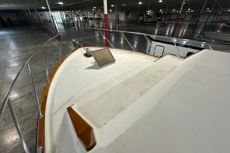 Slide: The Image of 1982 Egg Harbor 42 Flybridge Motoryacht in indoor storage, showcasing bow and railing. - 9
