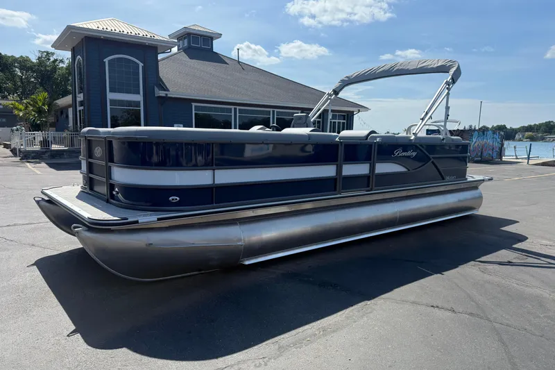 The Image of 2026 Bentley Pontoons Legacy 240 Cruise XL docked near a waterfront building. - 1