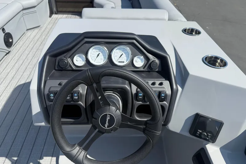 Slide: The Image of 2026 Bentley Pontoons Legacy 240 Cruise XL dashboard with steering wheel and gauges. - 13