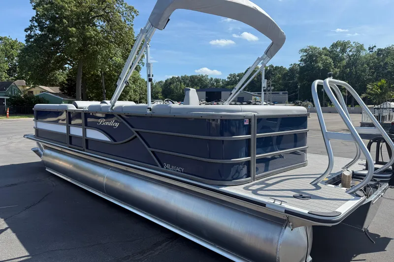Slide: The Image of 2026 Bentley Pontoons Legacy 240 Cruise XL pontoon boat with canopy, parked outdoors. - 3