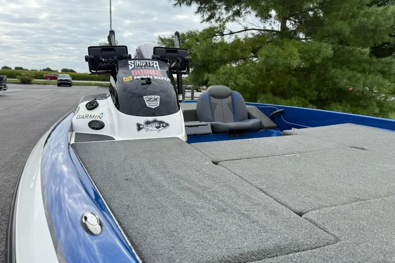Slide: The Image of 2018 SKEER ZX190 boat with Garmin electronics, parked outdoors near trees. - 11