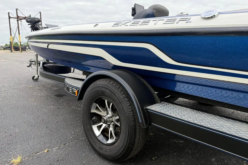 Slide: The Image of Blue 2018 SKEER ZX190 boat on trailer, featuring sleek design and alloy wheels. - 17