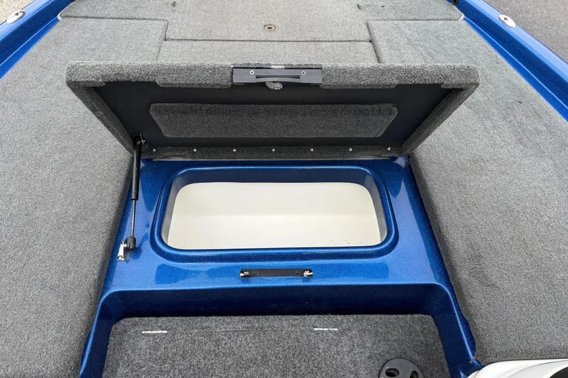 Slide: The Image of Open storage compartment on 2018 SKEER ZX190 boat, featuring blue and gray interior. - 20