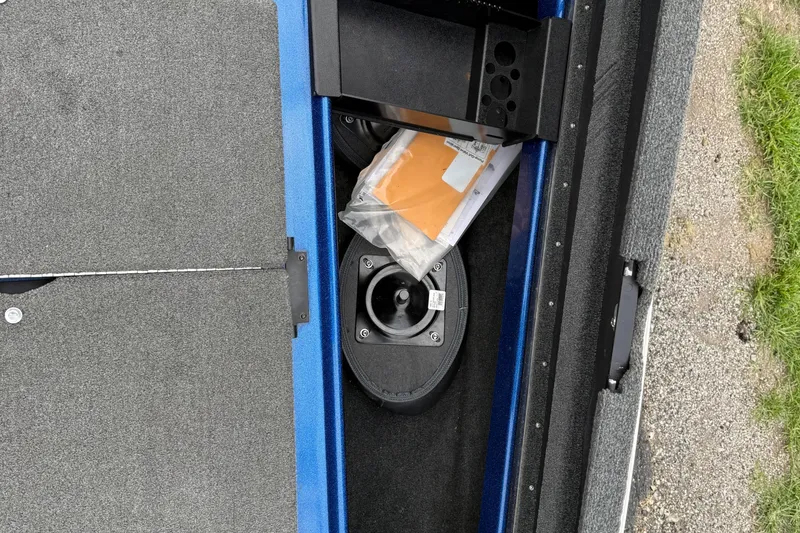 Slide: The Image of Interior view of a 2018 SKEER ZX190 boat storage compartment with documents and equipment. - 22