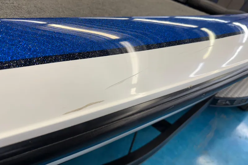 Slide: The Image of Close-up of 2018 SKEER ZX190 boat with blue and white detailing. - 25