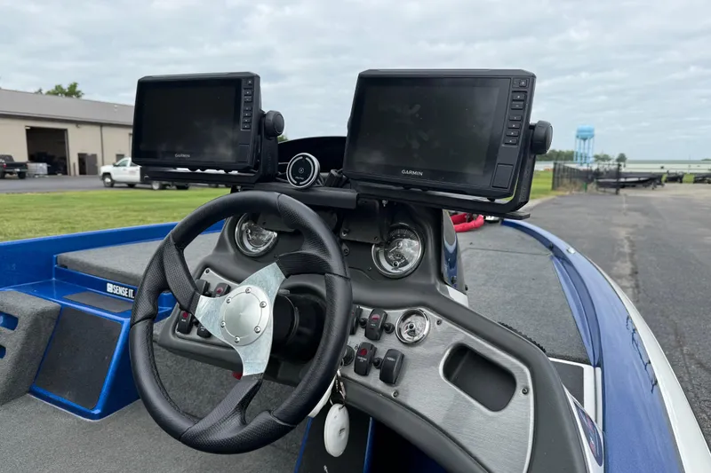Slide: The Image of 2018 SKEER ZX190 boat dashboard with dual Garmin displays and steering wheel. - 7