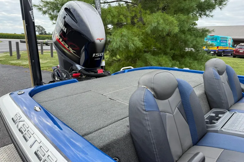 Slide: The Image of 2018 SKEER ZX190 boat with Yamaha 150 engine, blue and gray seating, outdoor setting. - 8