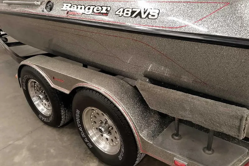 Slide: The Image of 1996 Ranger 487VS boat on trailer with metallic finish and Marathon tires. - 13