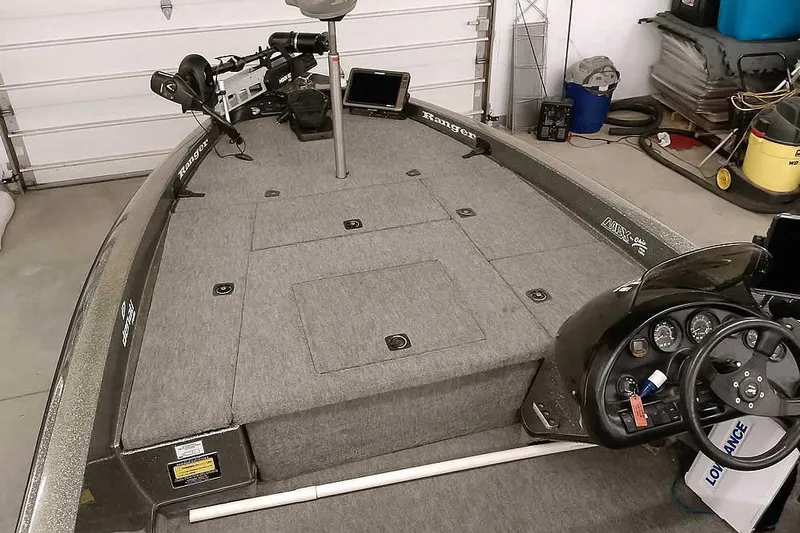 Slide: The Image of 1996 Ranger 487VS boat interior with fishing deck and control panel in a garage. - 15