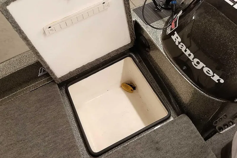 Slide: The Image of 1996 Ranger 487VS boat storage compartment with open lid, showcasing interior space. - 17