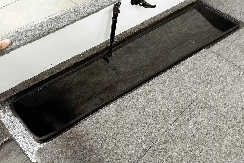 Slide: The Image of Open storage compartment in a 1996 Ranger 487VS boat, featuring carpeted interior. - 20