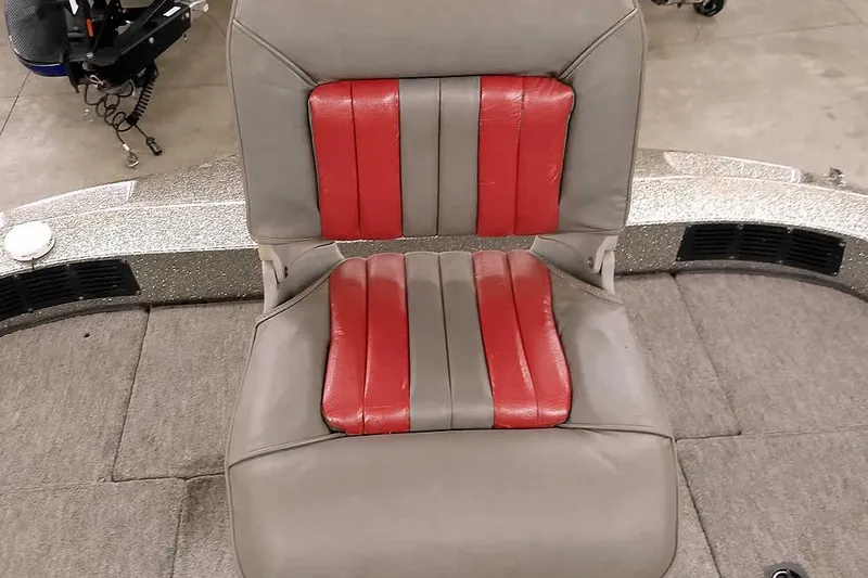 Slide: The Image of Gray and red seat of a 1996 Ranger 487VS boat, on a carpeted deck. - 26