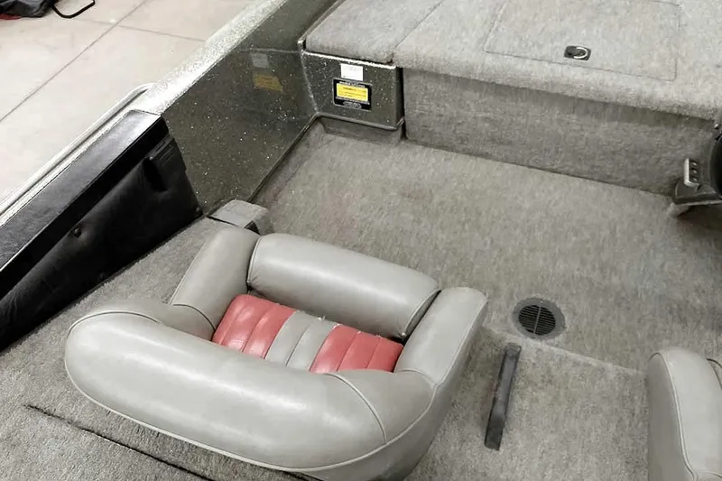 Slide: The Image of 1996 Ranger 487VS boat interior with gray and red seating, carpeted flooring. - 27