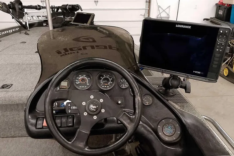 Slide: The Image of 1996 Ranger 487VS boat dashboard with steering wheel and Lowrance fishfinder. - 30