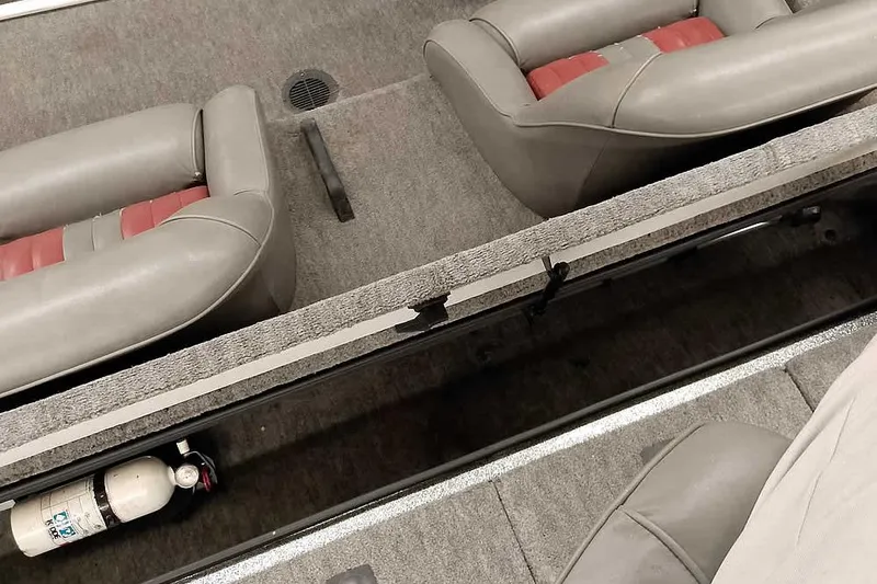 Slide: The Image of Interior of a 1996 Ranger 487VS boat with gray and red seating. - 34