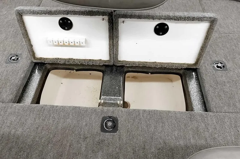 Slide: The Image of 1996 Ranger 487VS boat storage compartments with open lids, showcasing interior space. - 35