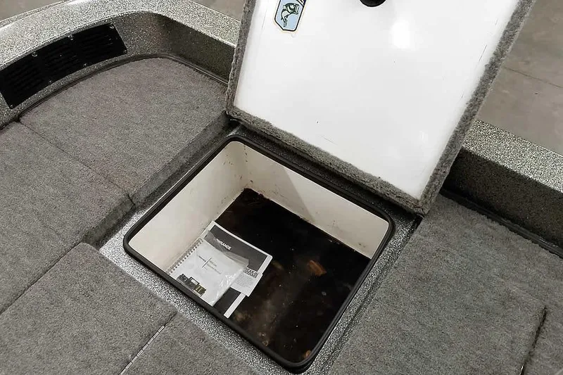 Slide: The Image of Open storage compartment in 1996 Ranger 487VS boat, showing manuals inside. - 36