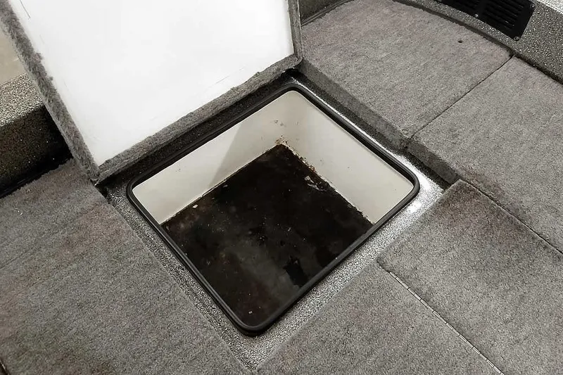 Slide: The Image of Open storage compartment in 1996 Ranger 487VS boat with carpeted flooring. - 37