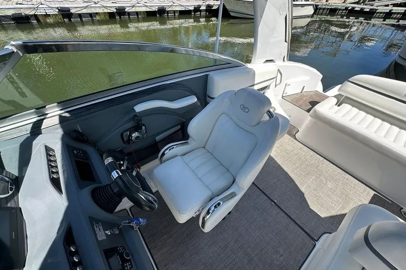 Slide: The Image of 2016 Cobalt R5 boat interior with helm, luxurious seating, and waterfront view. - 10