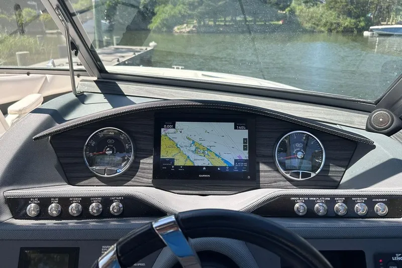 Slide: The Image of Dashboard of a 2016 Cobalt R5 boat with navigation display and controls. - 12