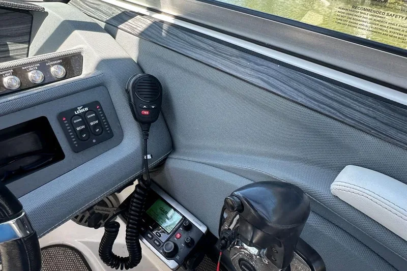 Slide: The Image of Interior of a 2016 Cobalt R5 boat showing control panel and communication equipment. - 13