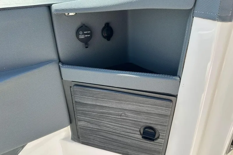 Slide: The Image of 2016 Cobalt R5 boat interior with audio input and storage compartment. - 14