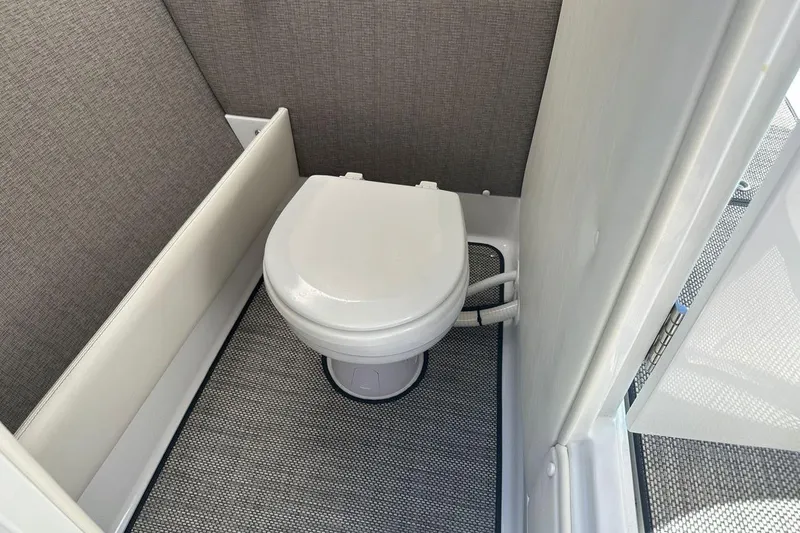 Slide: The Image of Compact marine toilet in a 2016 Cobalt R5 boat interior. - 15