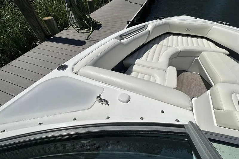 Slide: The Image of 2016 Cobalt R5 boat with white leather seating, docked by a wooden pier. - 17