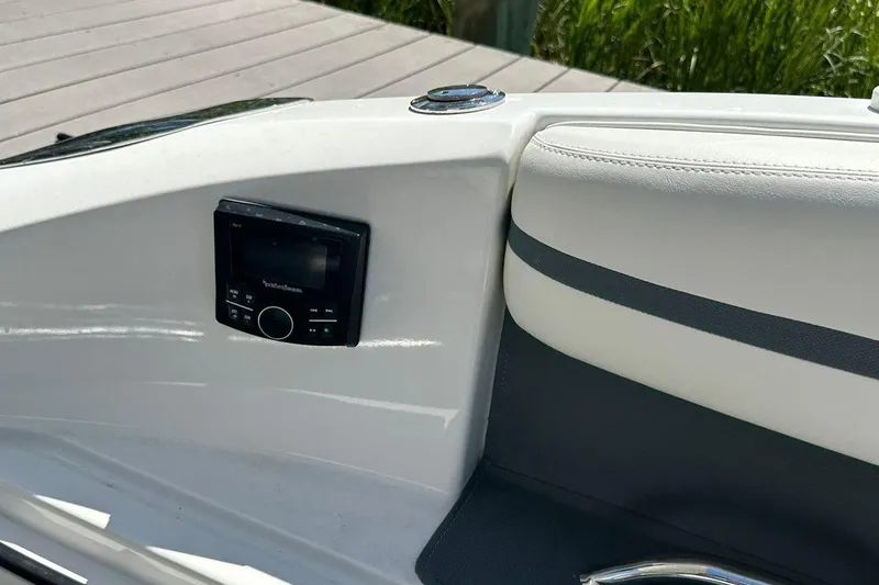 Slide: The Image of Interior of 2016 Cobalt R5 boat with audio control panel and cushioned seating. - 18