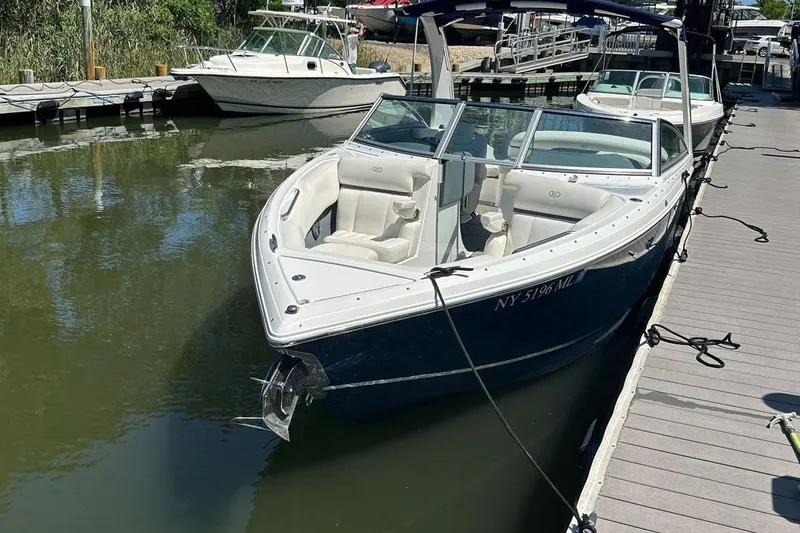 Slide: The Image of 2016 Cobalt R5 boat docked at marina, featuring sleek design and spacious seating. - 19