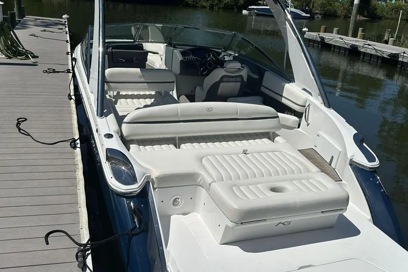 Slide: The Image of 2016 Cobalt R5 boat docked, featuring spacious white seating and sleek design. - 5