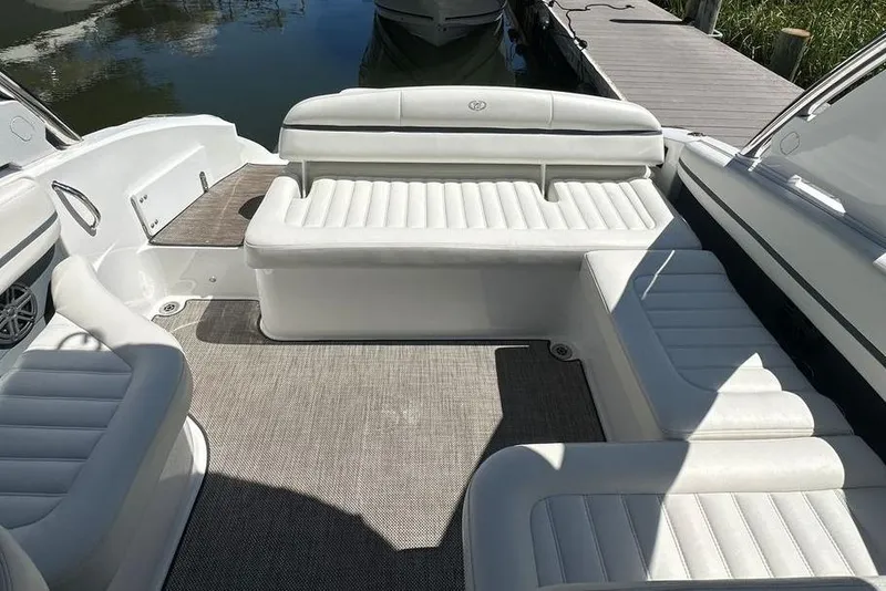 Slide: The Image of 2016 Cobalt R5 boat interior with white leather seating and carpeted flooring. - 8