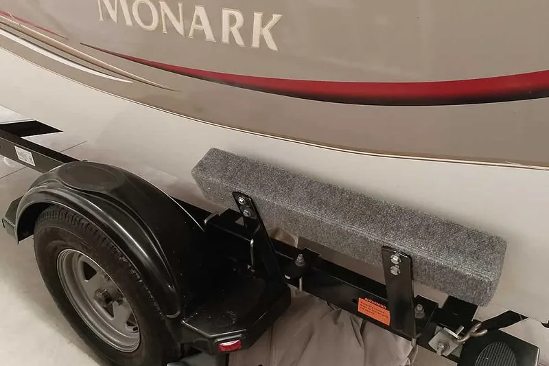 Slide: The Image of Trailer of a 2005 Monark King 185 boat with visible wheel and fender. - 13