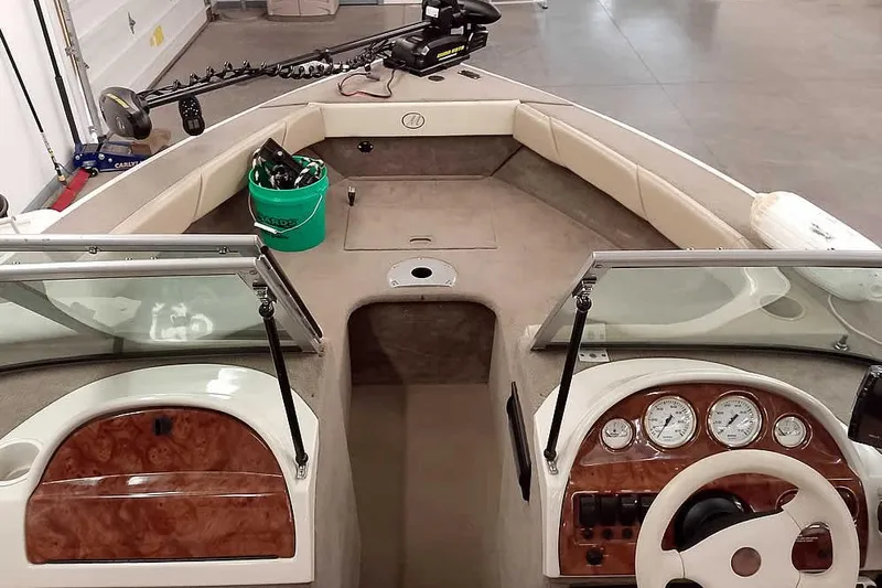 Slide: The Image of 2005 Monark King 185 boat interior with steering wheel, gauges, and seating area. - 15