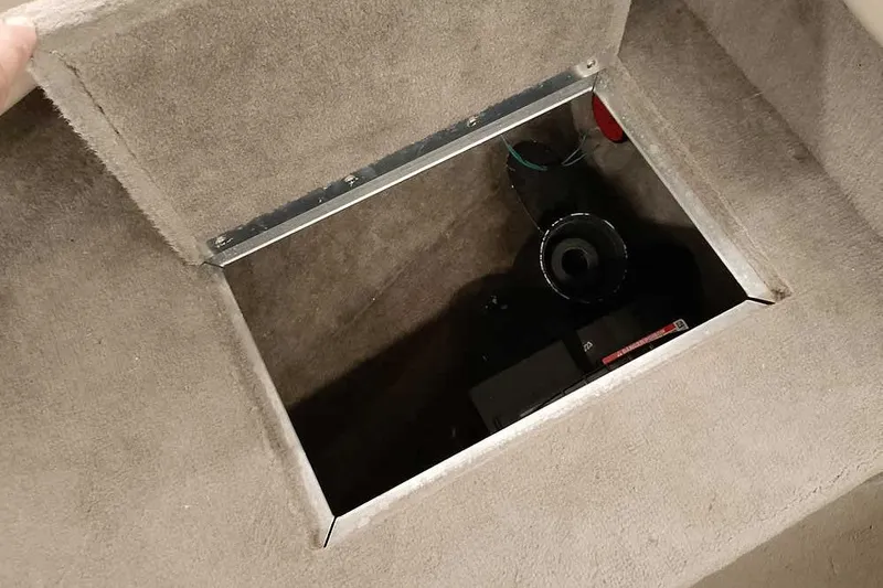 Slide: The Image of Open storage compartment in a 2005 Monark King 185 boat, revealing interior components. - 16